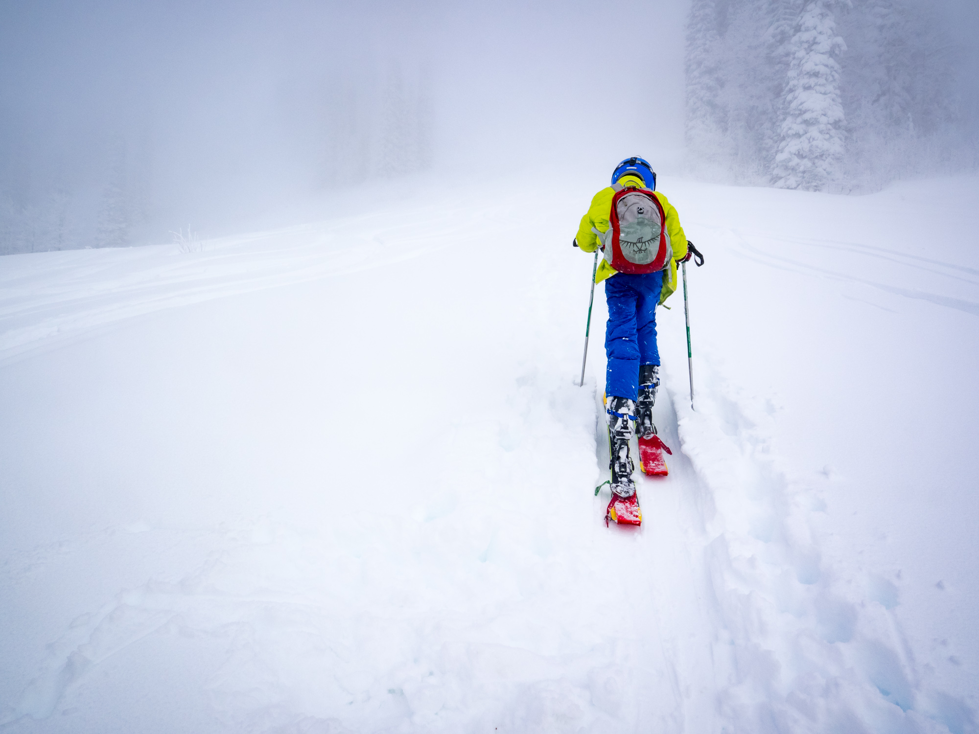 Young boy hiking for turns in fresh powder pre season at Brundage Mountain Resort in McCall, Idaho.
